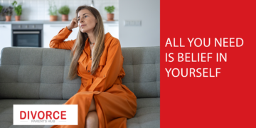 A woman looks pensive while sitting on a couch.