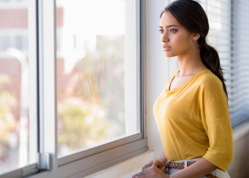 A woman looks out of the window.