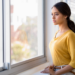 A woman looks out of the window.
