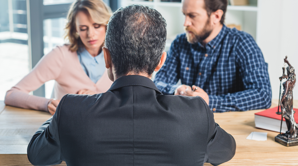 A couple mulls over a divorce option in a lawyer's office.