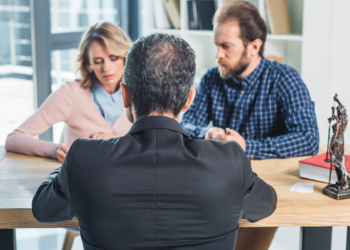 A couple mulls over a divorce option in a lawyer's office.