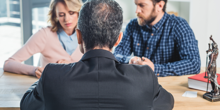 A couple mulls over a divorce option in a lawyer's office.