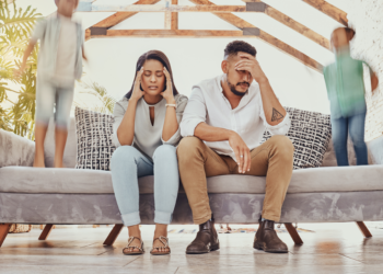 A couple exhibits irritation as the kids are making noise in the background.