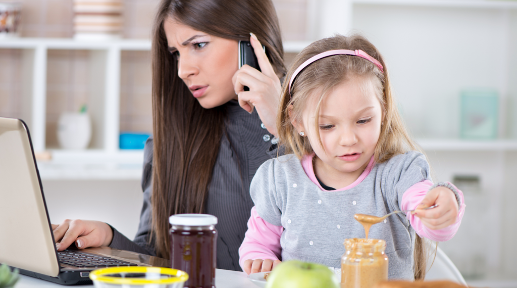 A single mom scrolls financial documents on a laptop.
