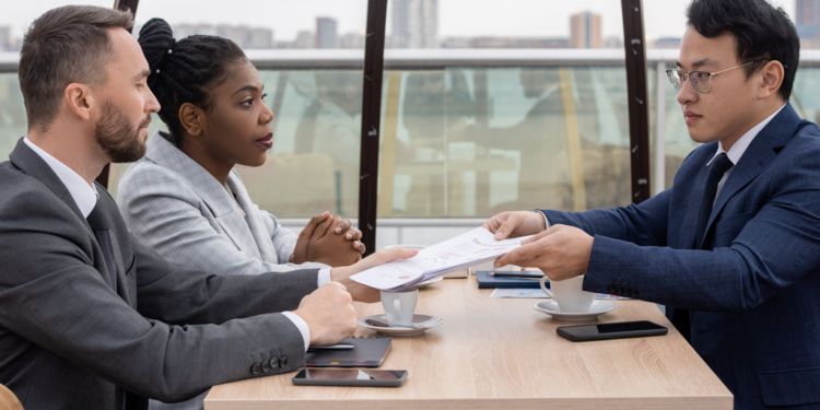 A couple holds negotiations with a family lawyer.