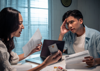 A couple sorts out financial documents during a divorce.