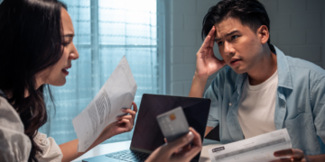 A couple sorts out financial documents during a divorce.