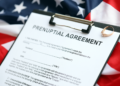 A prenuptial agreement is pictured with the USA flag in the background.