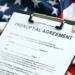 A prenuptial agreement is pictured with the USA flag in the background.