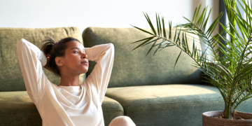 A woman relaxes in her home.