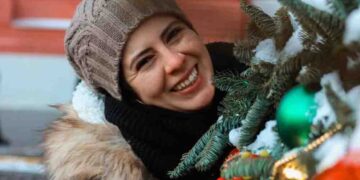 Girl enjoying Christmas decor outdoors