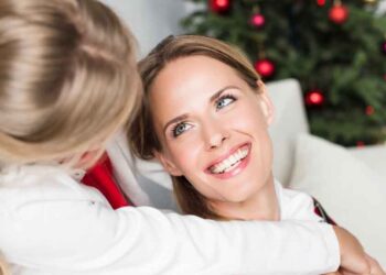 happy mother and daughter smiling at each other