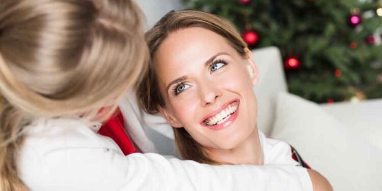 happy mother and daughter smiling at each other
