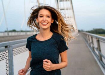 A young fit attractive happy fitness woman in city.