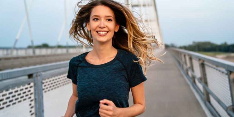 A young fit attractive happy fitness woman in city.