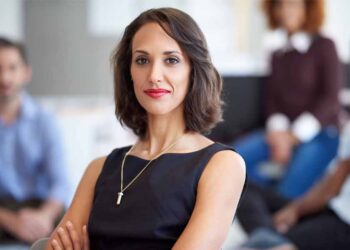 A confident businesswoman poses for a photo.