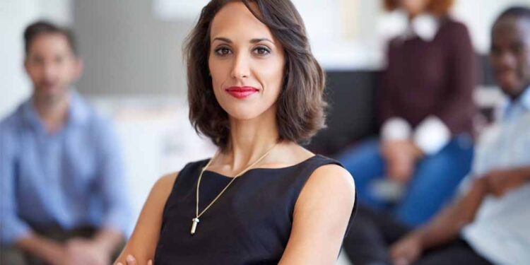 A confident businesswoman poses for a photo.